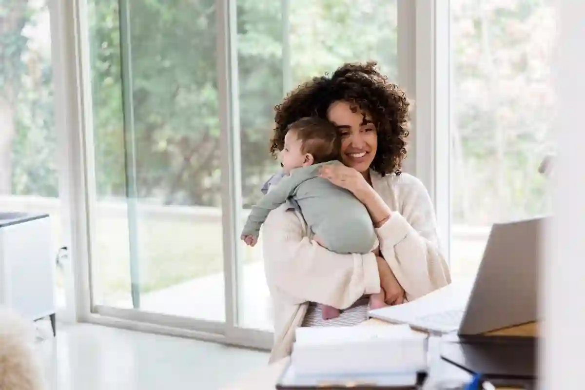 Smiling mom holding baby up to her shoulder