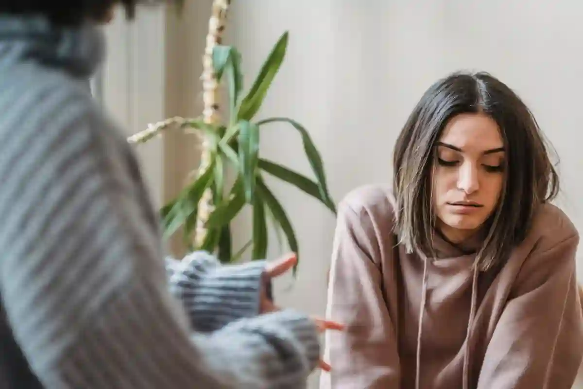 A woman having an upsetting conversation with someone off screen