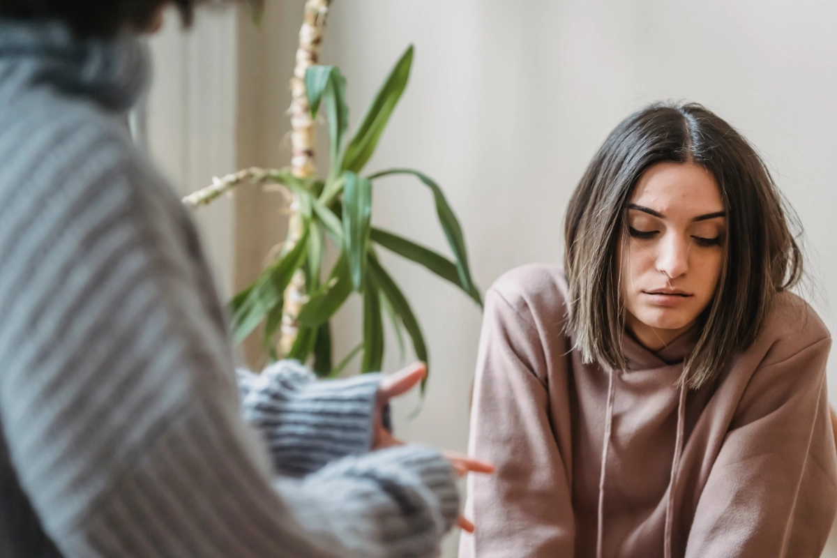 A woman having an upsetting conversation with someone off screen